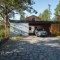 Southern view of the driveway to the house. The covered parking space is equipped with a wallbox for charging electric vehicles